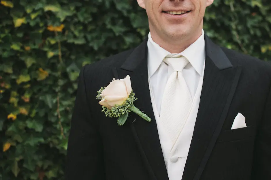 The image shows a bride and groom walking hand in hand surrounded by paparazzi while guests watch from a distance. The bride is wearing a stunning white gown, veil, and carrying a bouquet of flowers, while the groom is dressed in a black suit with a white shirt and black tie. The photo captures the excitement and glamour of celebrity weddings.