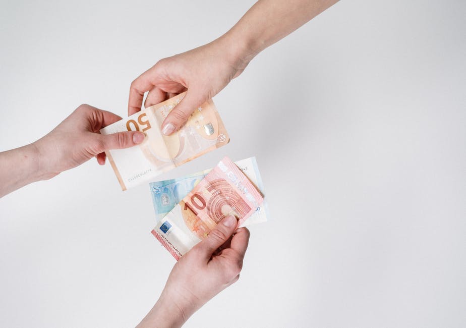 Hands exchanging currency from different countries to represent cross-border payments