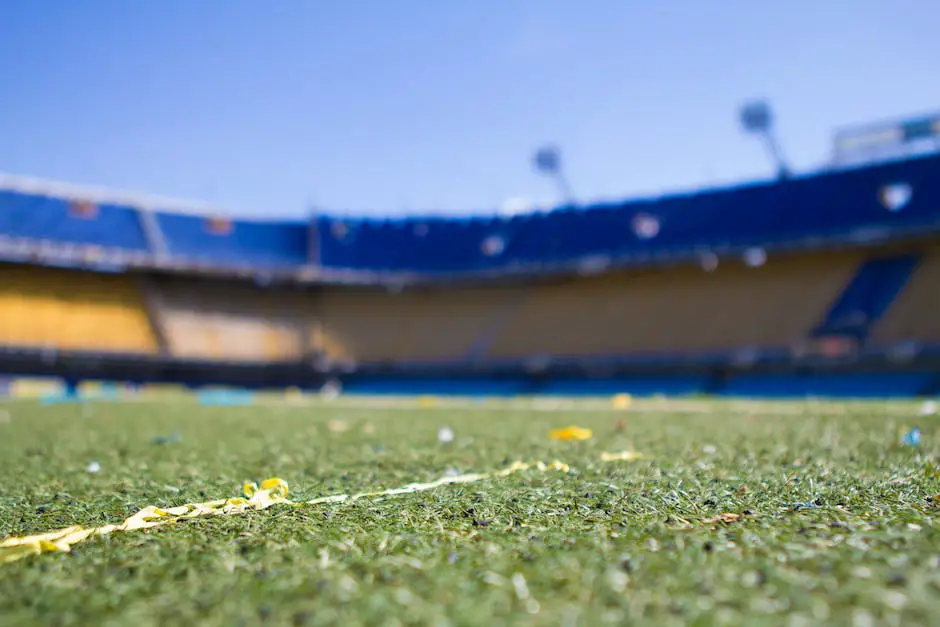 A picture of a football stadium filled with spectators and players on the pitch.