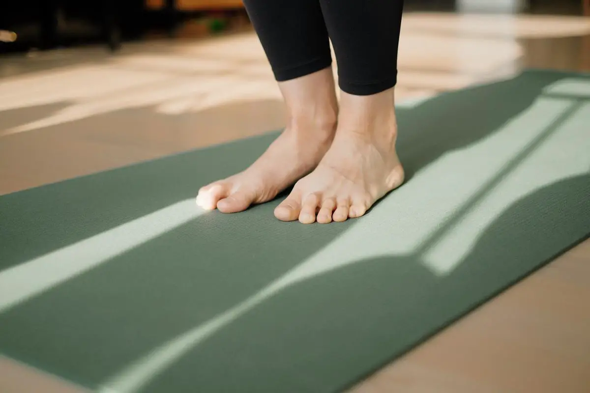 A drawing of Halle Berry stretching after a workout, with a water bottle and yoga mat nearby.