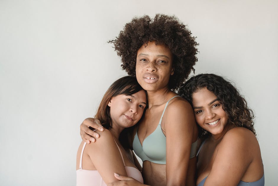 A photo of models showcasing Rihanna's Savage x Fenty line on the runway, featuring women of all shapes and sizes and various skin tones and abilities. The models are wearing colorful lingerie and loungewear pieces.