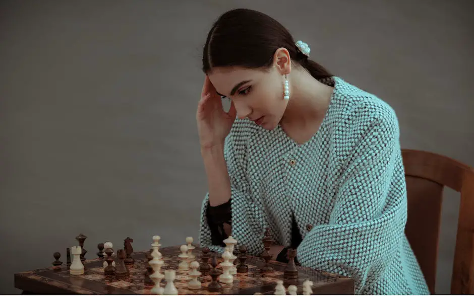A person sitting at a table, playing a game of chess with intense focus.