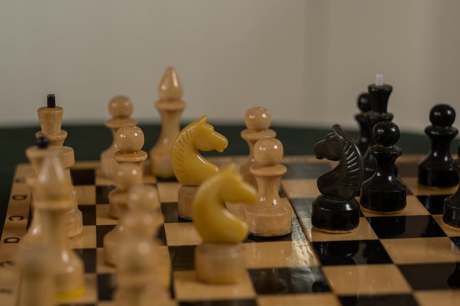 A group of diverse women play chess together with smiles on their faces