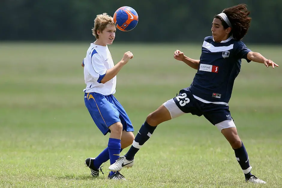 Young football player running with the ball on a grass field